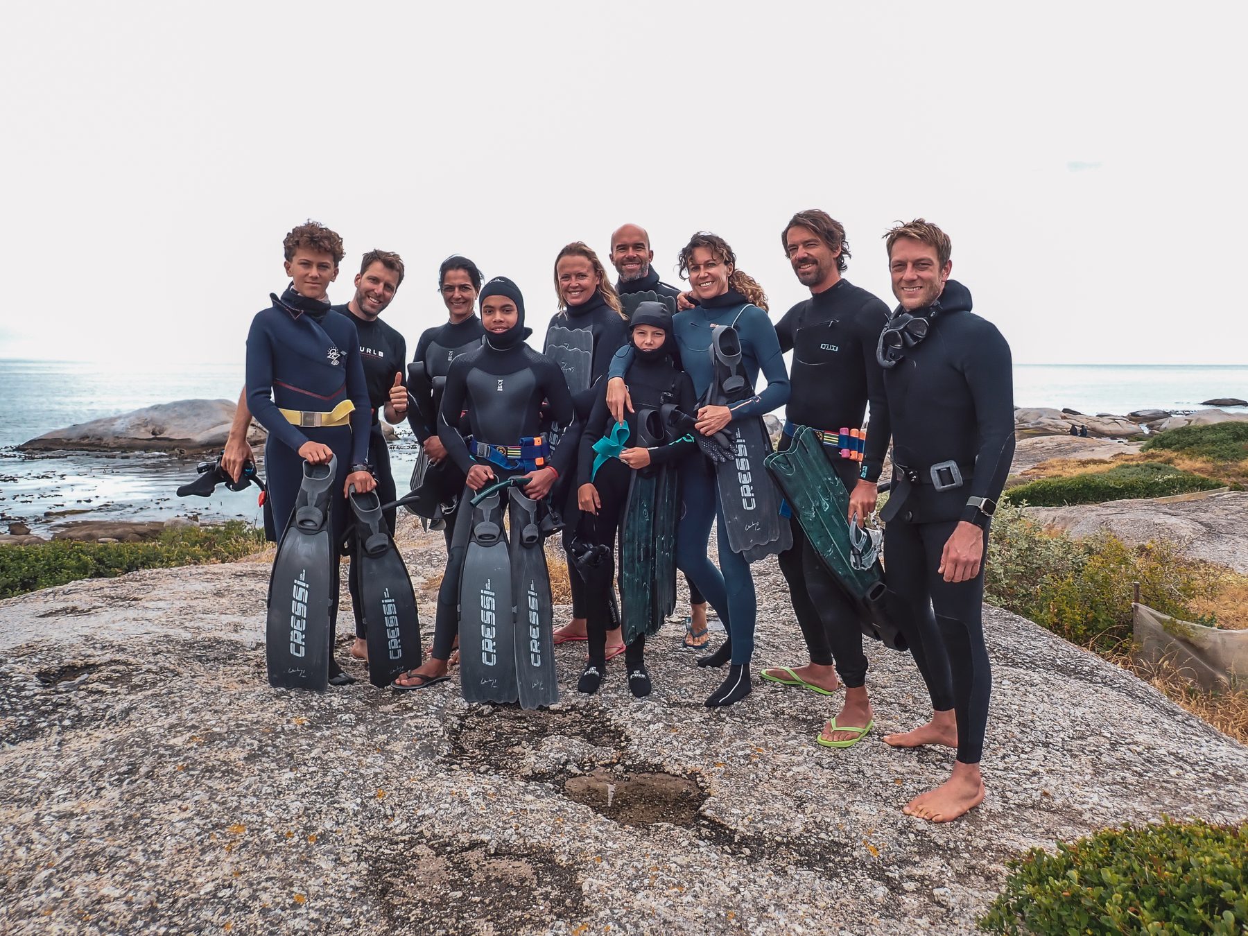 A group on the rocks before a dive
