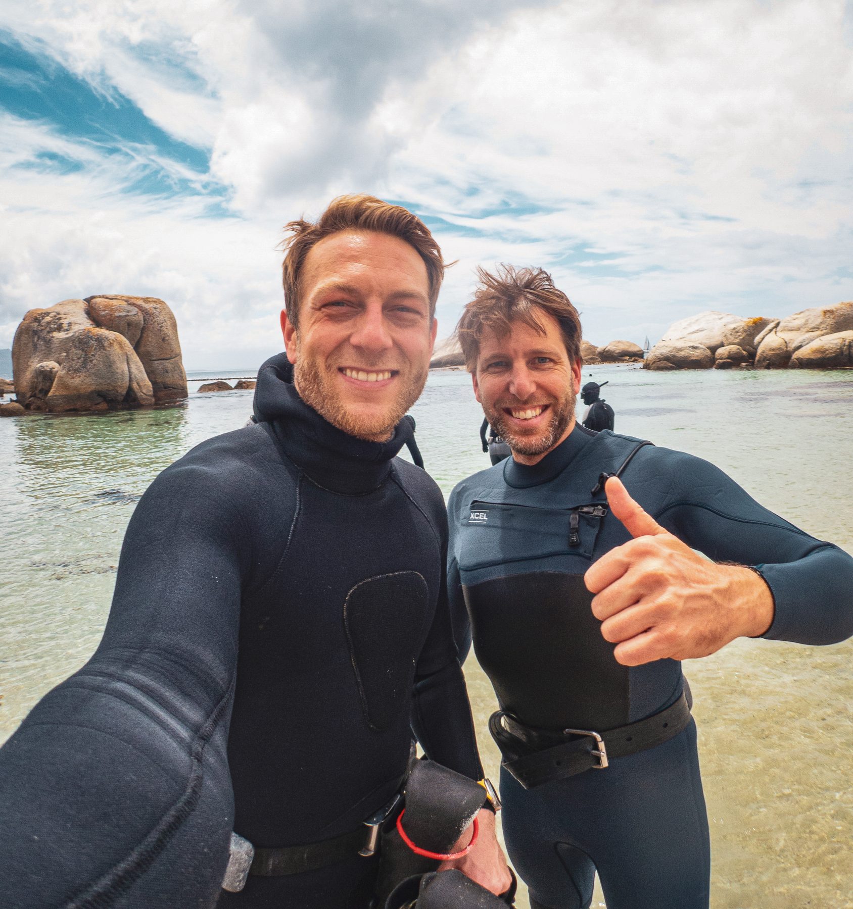 Two divers back on the beach after a dive